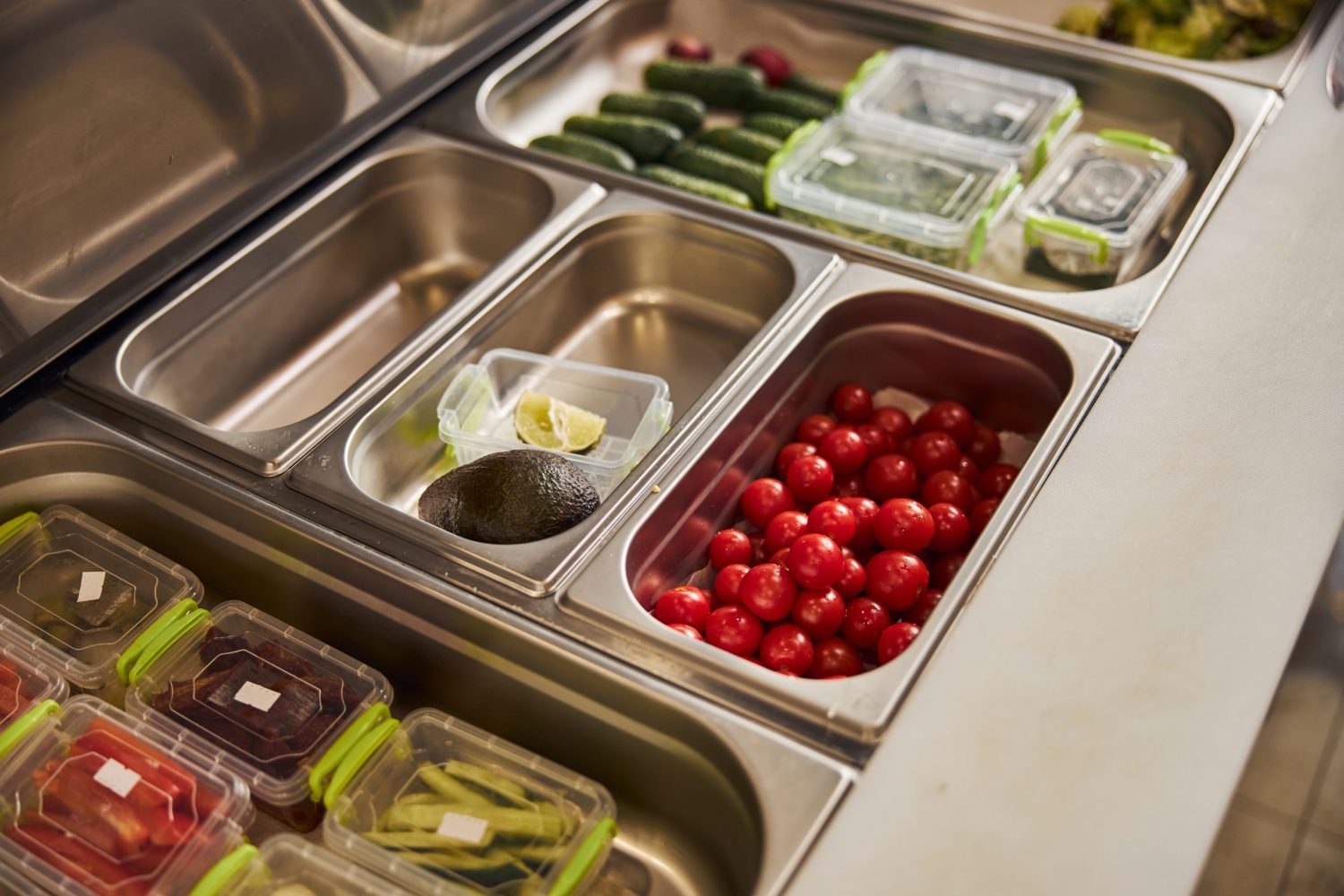 Containers with delicious fresh ingredients in cafe or pizzeria